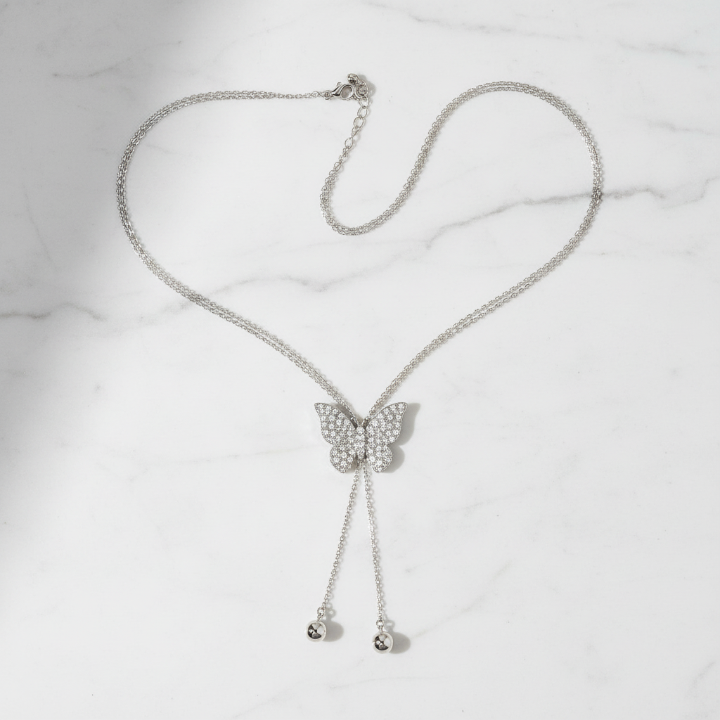 Crystal Butterfly Lariat Necklace flat lay marble