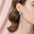 Teal Butterfly Drop Earrings worn on ear lifestyle shot